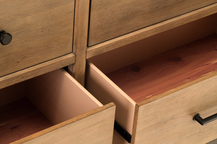 Wooden dresser with open drawer and closed drawers